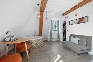 a living room with a tub and a table and a chair at Angel Townhouse in London