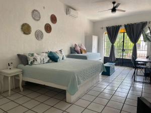 a bedroom with a bed in a room at Nueva Vista INN in Cruz de Huanacaxtle +21 photos