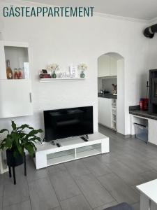 a living room with a flat screen tv on a stand at 2 Wohnungen im Refugium 2020 in Marienheide