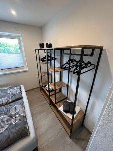 a room with a shelf with shoes and a couch at Ferienhaus Jannik in Hüde