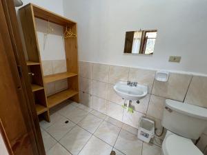 a bathroom with a toilet and a sink at Mirador Lodge in Chacas