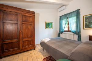 Ένα ή περισσότερα κρεβάτια σε δωμάτιο στο Le Casine Lazzareschi