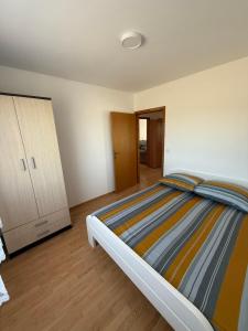 a bedroom with a large bed and a cabinet at Dream house in Laktaši