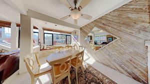 a dining room with a ceiling fan and a wooden wall at Upgraded 2 Bedroom Condo with Pool in Mammoth Lakes