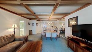 a living room with a couch and a table at Comfortable Condo - Gorgeous Slopeview and Access to 3 Hot Tubs Unit 303 at 1849 in Mammoth Lakes