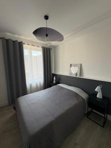 a bedroom with a bed and a clock on the wall at Le nid de CALI in Pont-à-Mousson