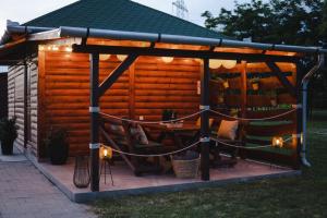 a pergola with a table and chairs under it at Boros Birtok 