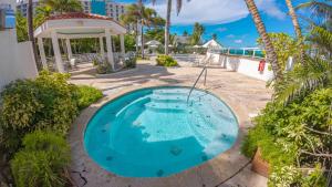 an empty swimming pool in the middle of a resort at Water Side Studio King Bed With Pool in San Juan
