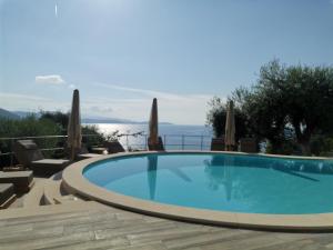 a swimming pool with a view of the ocean at Enjoy Lichnos Bay Village, Camping, Hotel and Apartments in Parga