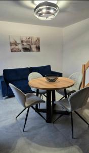 a dining room with a table and chairs and a couch at Mazurski Zakątek Orzyny in Orzyny