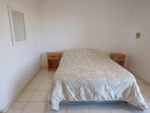 a bedroom with a bed and two night stands at Dpto las hermanas in Federación