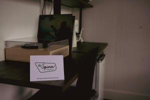 a table with a sign on top of it at The Spinn in Manzanita