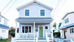 une maison blanche avec une porte verte dans l'établissement Gray Cottage On Windsor, à Cape May