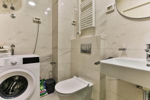 a bathroom with a washing machine and a sink at Apartment Alex in Bar +9 photos