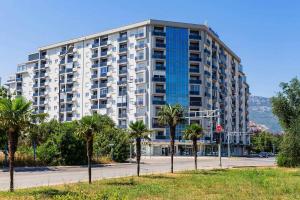 a large building with palm trees in front of it at Apartment Alex in Bar