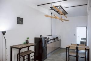 a kitchen with a black refrigerator and a table at Oasis Suites Pattaya in Pattaya Central +13 photos
