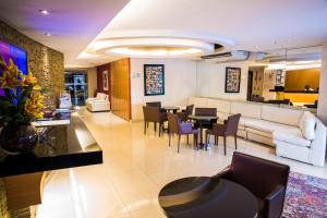 a living room with a couch and a table and chairs at Atlantis Copacabana Hotel in Rio de Janeiro