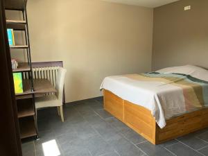 a bedroom with a bed and a desk and a chair at Maison Valence petit jardin in Valence