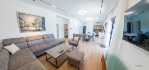a large living room with a couch and chairs at Villa Panorama Olive Hill in Mostar