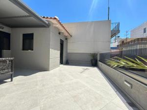 a balcony of a house with a patio at Ivory Style Maisonette near Downtown in Heraklio Town
