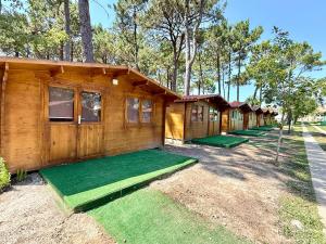 a row of lodges with grass in front of them at Camping Fraga Balada in Porto do Son