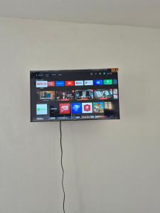 a flat screen tv hanging on a wall at OMY Apartments Nagua 2A in Nagua