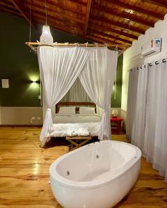 a white bath tub in a room with a bed at Smart Hotel Reserva Campos do Jordão in Campos do Jordão +21 photos