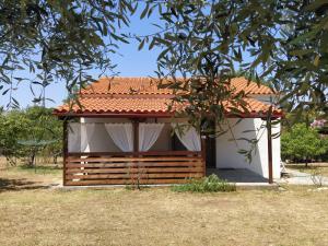 a small house with a red roof and a tree at SeaSaos in Samothráki