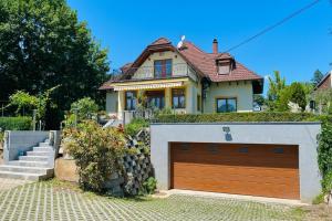 a house with a garage door in front of it at Mikes Home in Balatonfüred