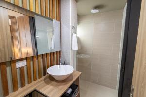 a bathroom with a white sink and a shower at Apartasuite Stay & Relax Itagui in Itagüí +8 photos