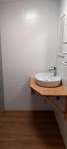 a bathroom with a sink on a wooden counter at Happy Horse Sosnowa Góra in Przetoczyno