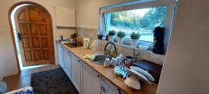 a kitchen with a sink and a window at Happy Horse Sosnowa Góra in Przetoczyno +13 photos