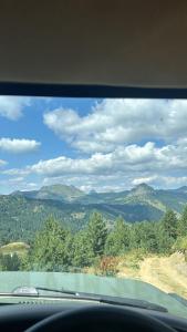 a view of the mountains from a car window at Aleos cabin in Kolgecaj +1 photo