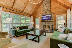 a living room with a couch and a fireplace at Hot Tub Soaks Starlit Smores Fireside Reads Nearby Golf Pools Trails - Wandering Creek in Dawsonville