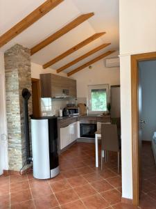 a kitchen with a refrigerator in the middle of a room at Apartment Maja in Dobrinj