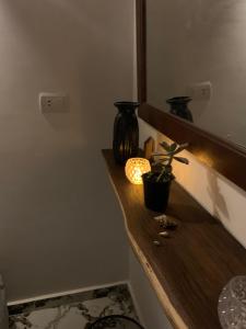 a counter with two vases and a plant on it at Rayan stay 1 in Dahab +2 photos