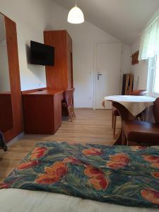 a living room with a table and a rug on the floor at Bursztyn in Rewal +37 photos