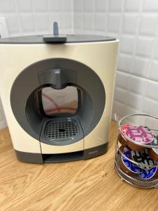 a toaster oven sitting on a table next to a basket of cookies at Museum Apartment by City Park Budapest in Budapest