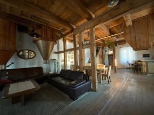 a living room with a couch and a table at Stary młyn nad Tywą in Gryfino