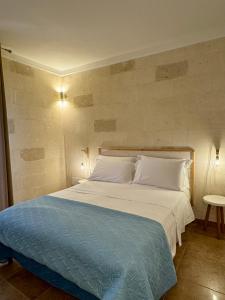 En eller flere senge i et værelse på Il Pero di Casa Portacrànni