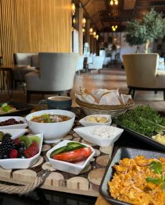 a table topped with bowls and plates of food at إيلاف الدمام للوحدات السكنية المخدومة in Dammam