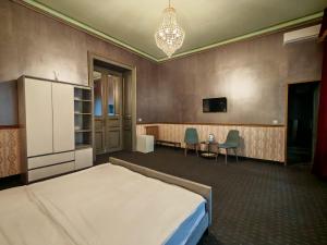 a bedroom with a bed and a table and chairs at Nostalgia Old City Bucharest in Bucharest +22 photos