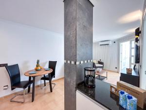 a kitchen and living room with a table and chairs at Modern appartment with sea views in Sabinillas in San Luis de Sabinillas +16 photos