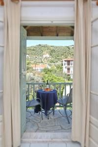 een kamer met een tafel en stoelen op een balkon bij Pansion Prodromina in Skopelos Town