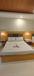 a bedroom with a large bed with a wooden headboard at Villa de Miguel in Migit +35 photos