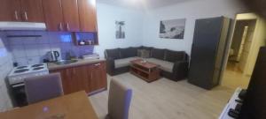 a kitchen with a couch and a living room at House Max B in Mostar