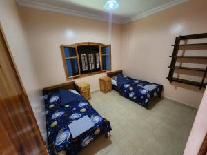 a room with two beds and a bunk bed at la Citronnelle in Oualidia +20 photos