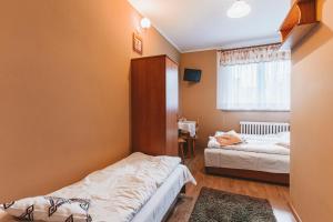 Posteľ alebo postele v izbe v ubytovaní Pokoje Gościnne U Babci
