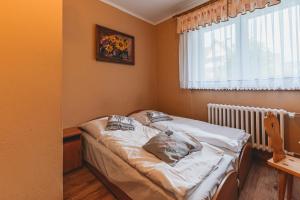 Posteľ alebo postele v izbe v ubytovaní Pokoje Gościnne U Babci