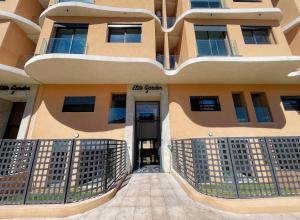 a building with the entrance to the building at Luxury Modern Studio with Netflix, Kitchen and Free Parking Elite Garden, Marrakesh in Aït Saïd